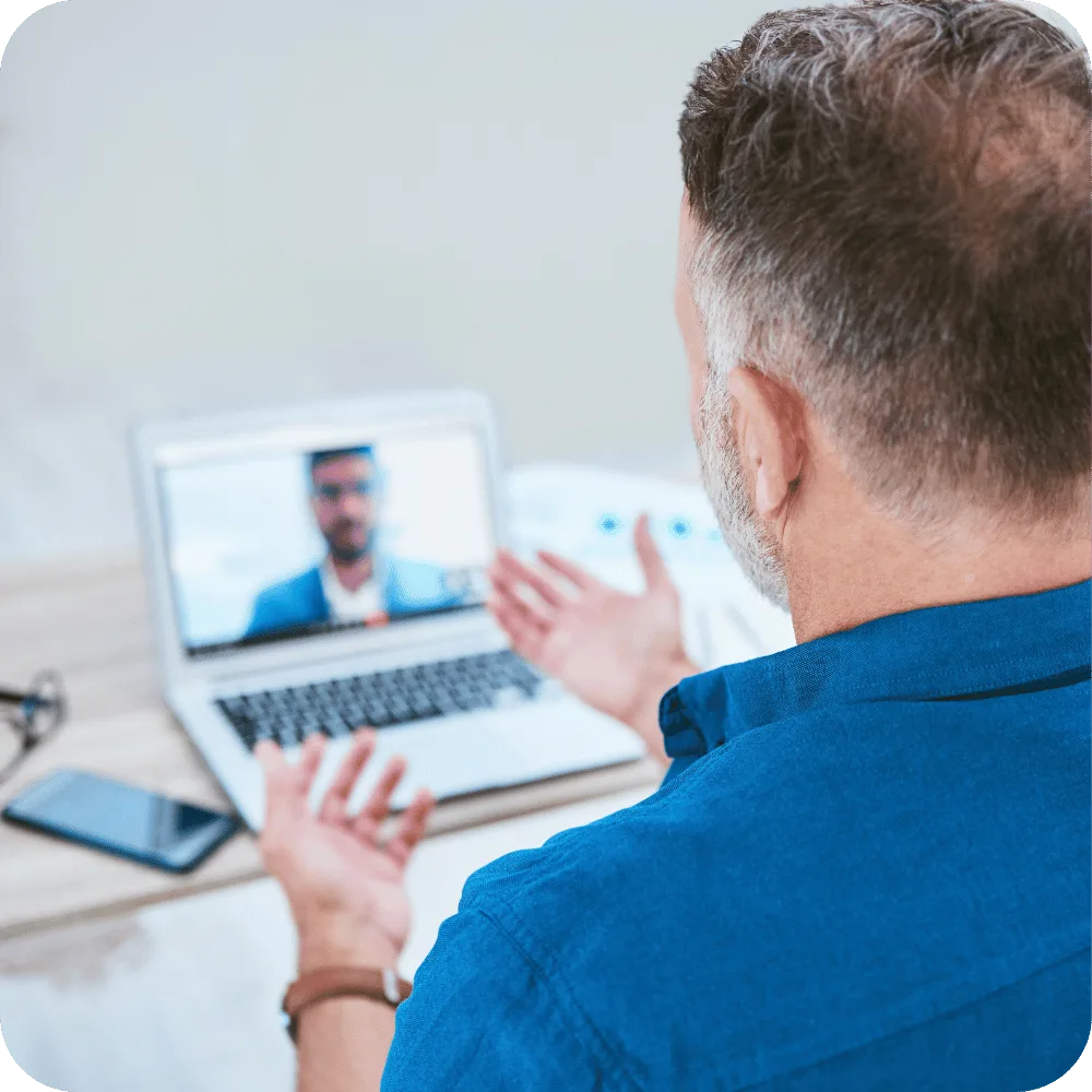 A business owner talks with a mentor on a virtual mentoring call.
