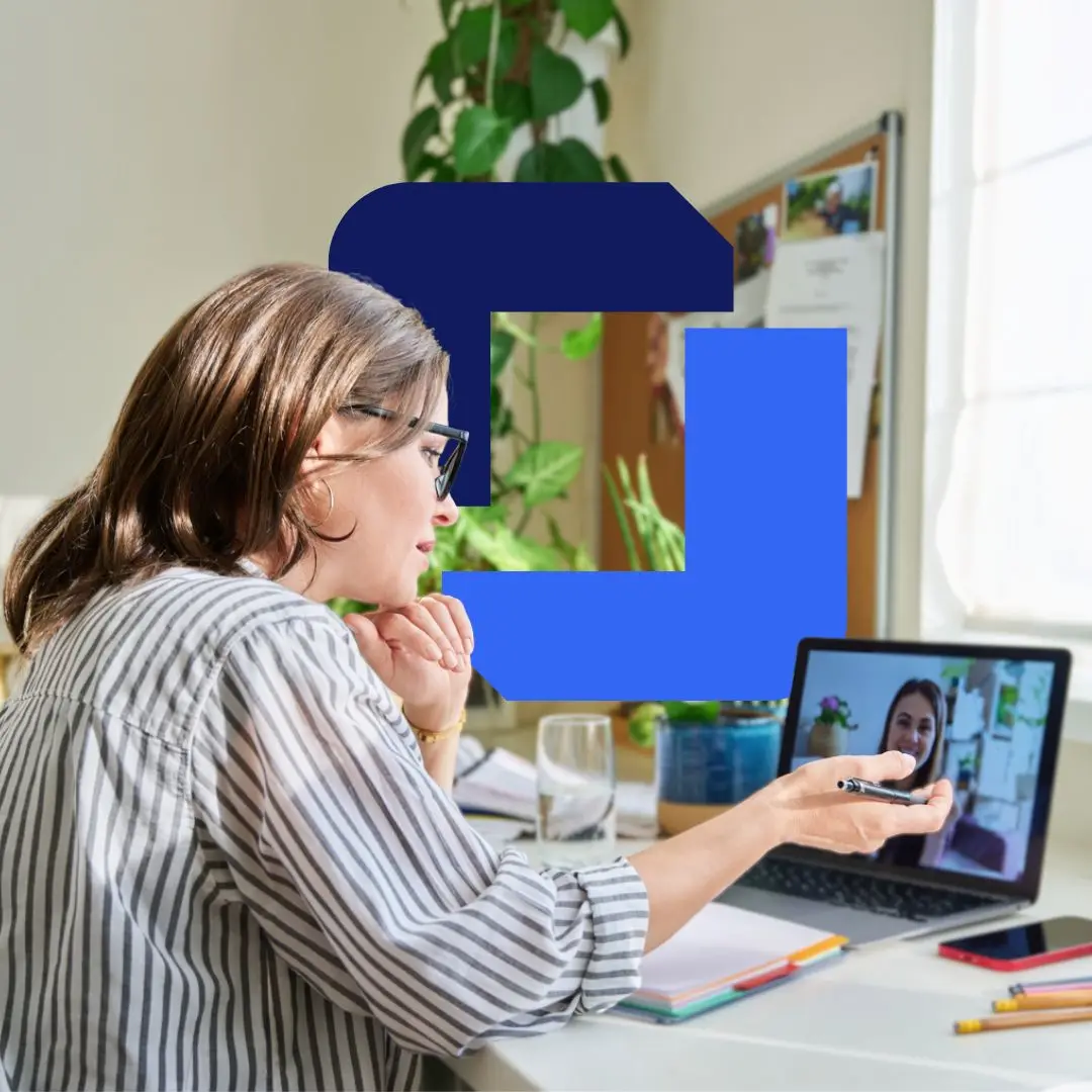 A business owner talks through her plan on a video call with a mentor